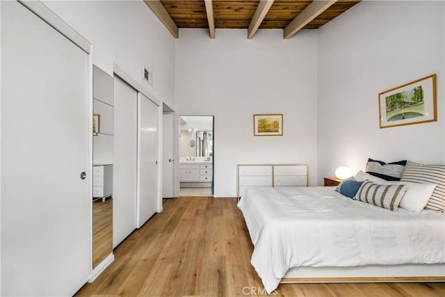 20 Mandrake Way, Irvine, CA 92612 - bedroom featuring wood ceiling with exposed beams, light wood-style flooring, a towering ceiling, and ensuite bathroom