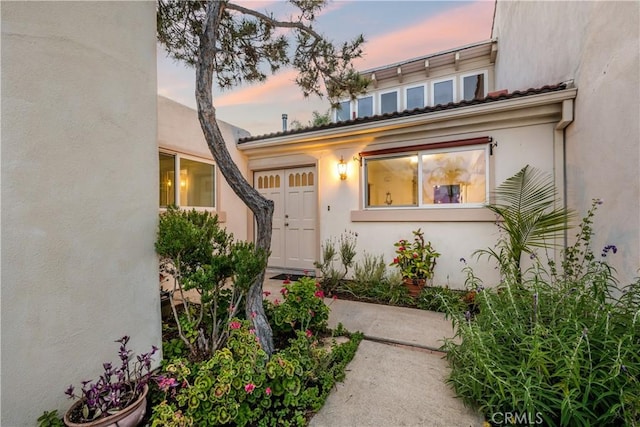 20 Mandrake Way, Irvine, CA 92612 - exterior entry at dusk with stucco siding