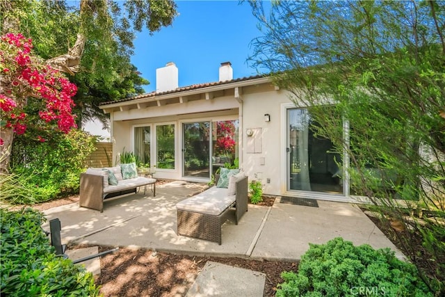 20 Mandrake Way, Irvine, CA 92612 - rear view of property with a chimney, stucco siding, a patio area, and an outdoor living space