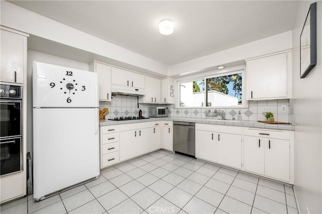 20 Mandrake Way, Irvine, CA 92612 - kitchen featuring black appliances, tasteful backsplash, white cabinets, under cabinet range hood, and tile countertops