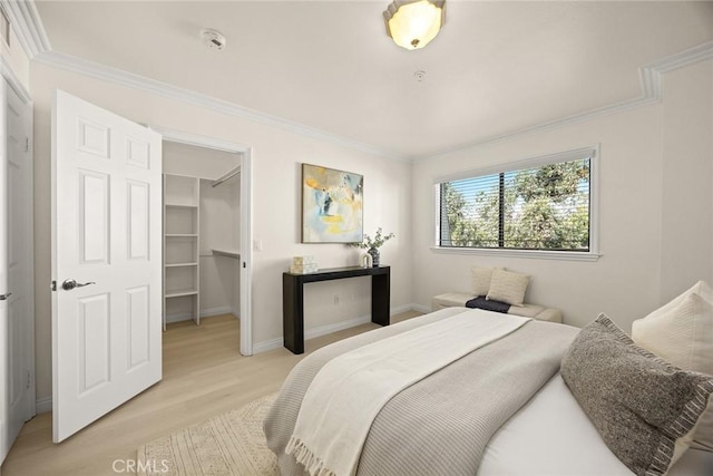 70 N Catalina Ave Unit 306, Pasadena, CA 91106 - bedroom with a spacious closet, light wood-type flooring, ornamental molding, a closet, and baseboards