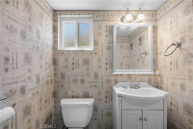 20015 Gilbert Dr, Canyon Country, CA 91351 - bathroom featuring toilet, vanity, and wallpapered walls