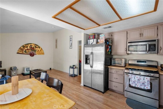 20015 Gilbert Dr, Canyon Country, CA 91351 - kitchen featuring appliances with stainless steel finishes, light wood-style flooring, and light countertops