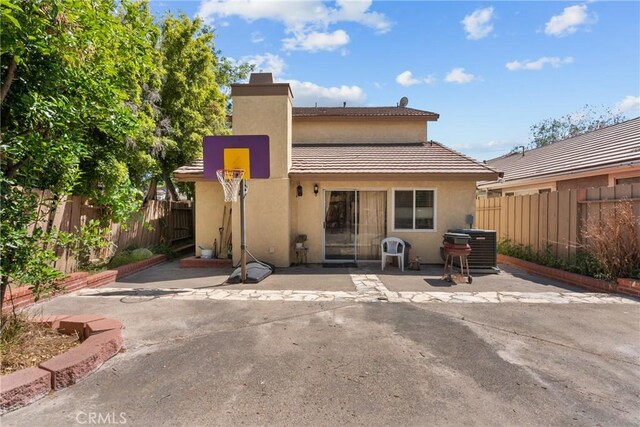 20015 Gilbert Dr, Canyon Country, CA 91351 - rear view of property with stucco siding, a patio, and a chimney