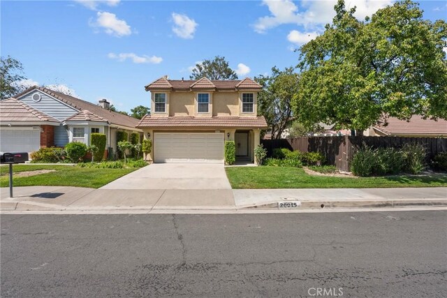 20015 Gilbert Dr, Canyon Country, CA 91351 - traditional-style home featuring driveway, stucco siding, a tiled roof, and a garage