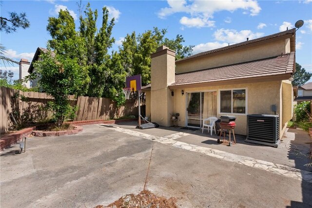 20015 Gilbert Dr, Canyon Country, CA 91351 - back of house featuring stucco siding, cooling unit, a patio, and a chimney