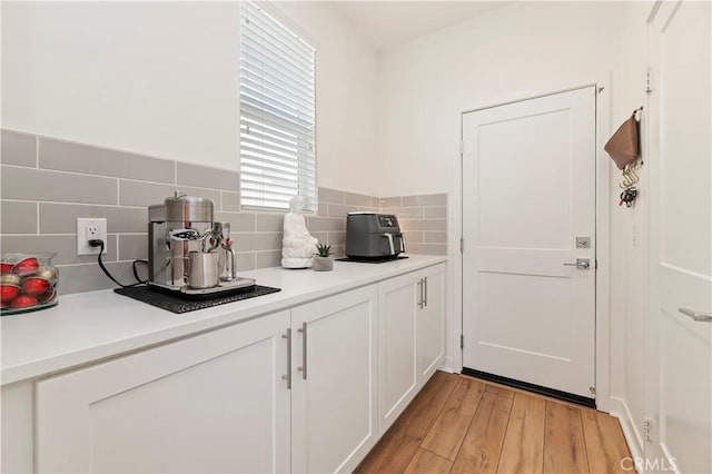 1890 Pele Way, Corona, CA 92882 - kitchen featuring light countertops, decorative backsplash, white cabinetry, and light wood-style floors