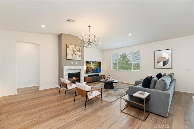 1890 Pele Way, Corona, CA 92882 - living room featuring baseboards, light wood-style floors, a chandelier, a warm lit fireplace, and recessed lighting