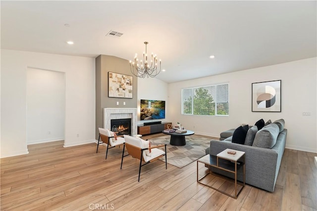 1890 Pele Way, Corona, CA 92882 - living room featuring light wood-type flooring, a lit fireplace, a chandelier, recessed lighting, and lofted ceiling