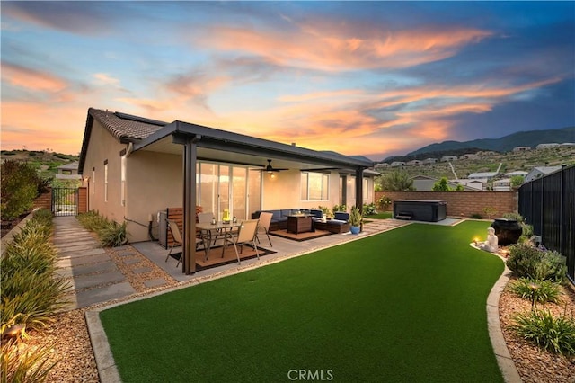1890 Pele Way, Corona, CA 92882 - back of house featuring a hot tub, outdoor lounge area, a fenced backyard, a patio, and stucco siding