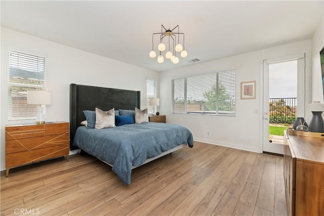 1890 Pele Way, Corona, CA 92882 - bedroom featuring access to exterior, light wood-style floors, and baseboards