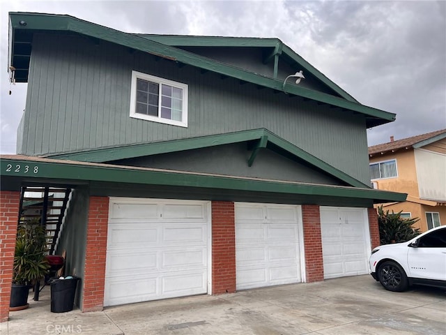 2238 S Center St, Santa Ana, CA 92704 - view of property exterior featuring brick siding, concrete driveway, and a garage