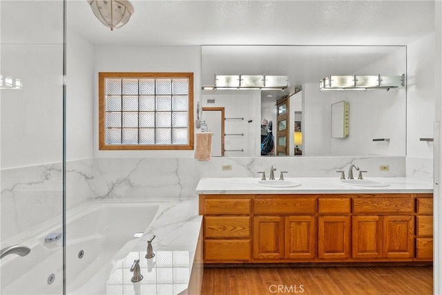 52 Hidden Valley Rd, Monrovia, CA 91016 - full bathroom featuring double vanity, a jetted tub, and wood finished floors