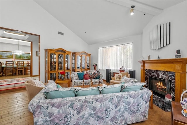 52 Hidden Valley Rd, Monrovia, CA 91016 - living room featuring hardwood / wood-style floors, a high end fireplace, beamed ceiling, and high vaulted ceiling