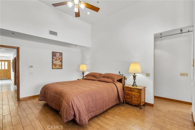 52 Hidden Valley Rd, Monrovia, CA 91016 - bedroom with light wood-style flooring, baseboards, a high ceiling, and a ceiling fan