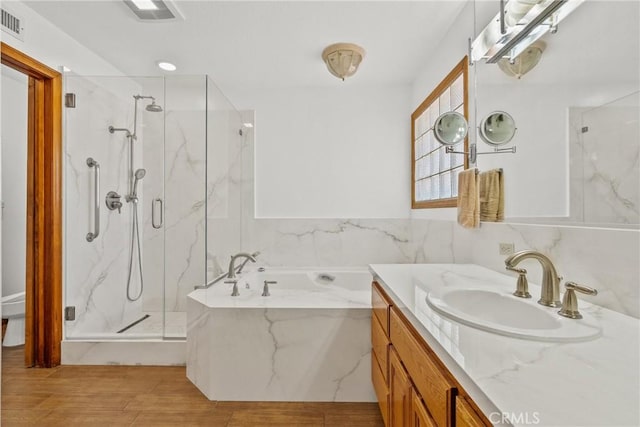 52 Hidden Valley Rd, Monrovia, CA 91016 - bathroom with a marble finish shower, a bath, vanity, and wood finished floors
