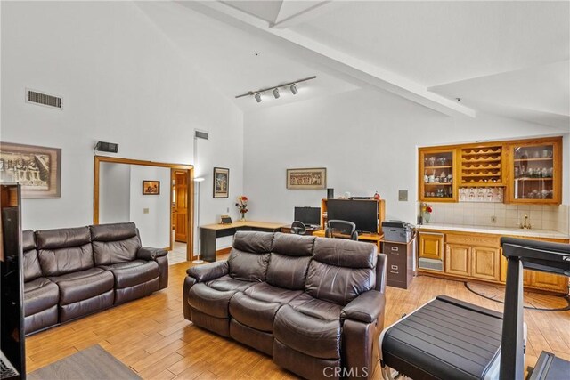 52 Hidden Valley Rd, Monrovia, CA 91016 - living room with wet bar, light wood-style floors, beam ceiling, an office area, and track lighting