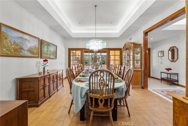 52 Hidden Valley Rd, Monrovia, CA 91016 - dining area with a raised ceiling, light wood finished floors, and a chandelier
