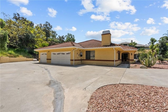 52 Hidden Valley Rd, Monrovia, CA 91016 - mediterranean / spanish-style house with a tiled roof, stucco siding, a garage, asphalt driveway, and a chimney
