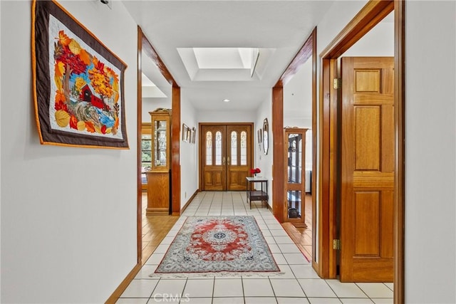 52 Hidden Valley Rd, Monrovia, CA 91016 - hallway featuring light tile patterned flooring, a skylight, baseboards, and a raised ceiling