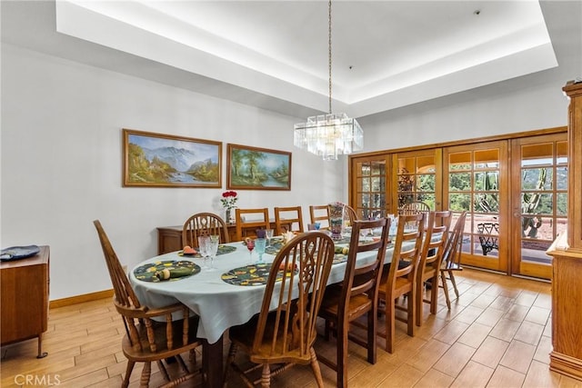 52 Hidden Valley Rd, Monrovia, CA 91016 - dining space with a raised ceiling, light wood-style floors, a chandelier, and baseboards