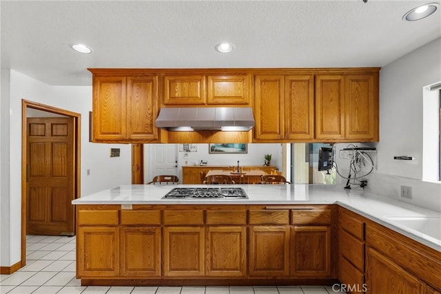 52 Hidden Valley Rd, Monrovia, CA 91016 - kitchen featuring ventilation hood, stainless steel gas cooktop, brown cabinetry, a peninsula, and recessed lighting