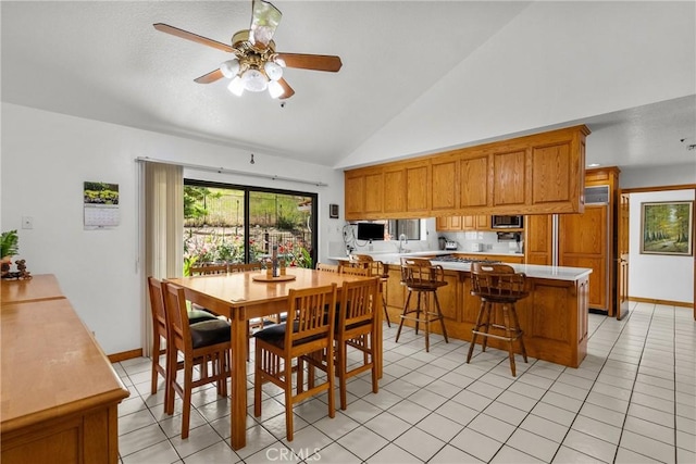 52 Hidden Valley Rd, Monrovia, CA 91016 - dining space with high vaulted ceiling, a ceiling fan, light tile patterned floors, and baseboards