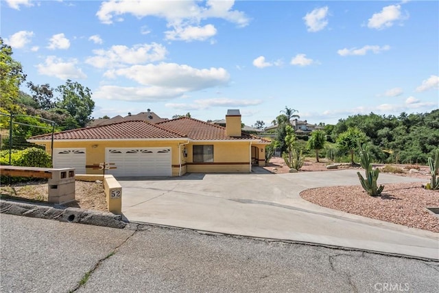 52 Hidden Valley Rd, Monrovia, CA 91016 - view of front of property featuring driveway, an attached garage, a tile roof, stucco siding, and a chimney