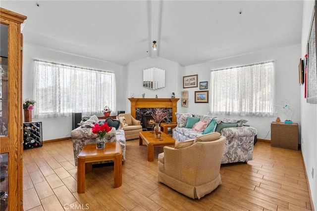 52 Hidden Valley Rd, Monrovia, CA 91016 - living room with vaulted ceiling, light wood-type flooring, a premium fireplace, and baseboards