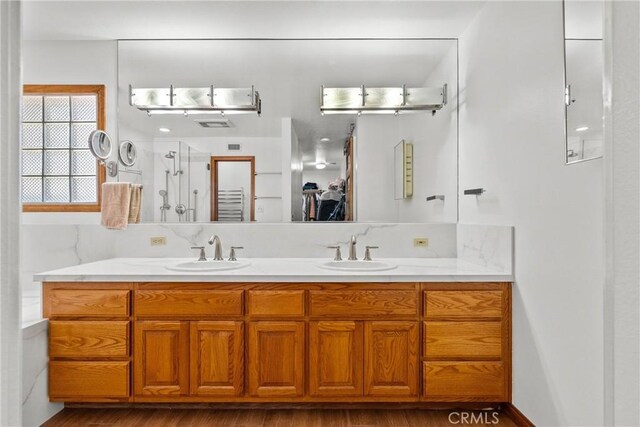 52 Hidden Valley Rd, Monrovia, CA 91016 - full bathroom featuring double vanity, walk in shower, wood finished floors, and a closet