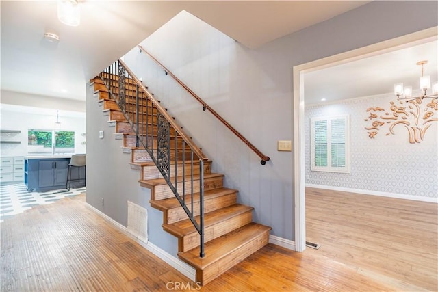 803 Crescent Dr, Monrovia, CA 91016 - staircase featuring wood finished floors, a chandelier, and wallpapered walls