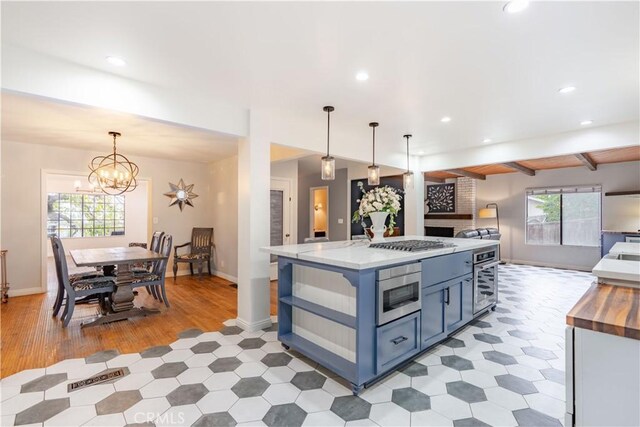 803 Crescent Dr, Monrovia, CA 91016 - kitchen featuring appliances with stainless steel finishes, open floor plan, recessed lighting, wood counters, and blue cabinets