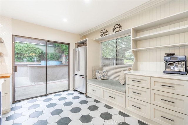 803 Crescent Dr, Monrovia, CA 91016 - kitchen with freestanding refrigerator, open shelves, light countertops, healthy amount of natural light, and crown molding