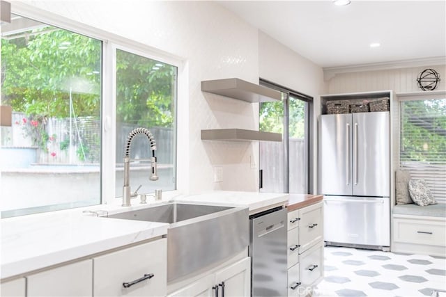 803 Crescent Dr, Monrovia, CA 91016 - kitchen with appliances with stainless steel finishes, open shelves, light flooring, white cabinetry, and light stone countertops