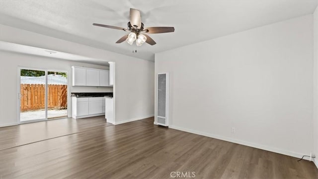3637 Stauss Ave, Oroville, CA 95966 - unfurnished room featuring a heating unit, dark wood finished floors, ceiling fan, and baseboards