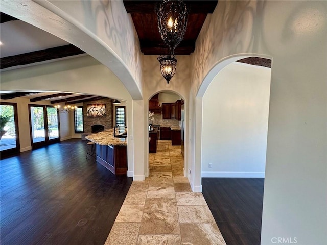 1415 Via Vallarta, Riverside, CA 92506 - kitchen with open floor plan, a chandelier, beamed ceiling, arched walkways, and wood finished floors