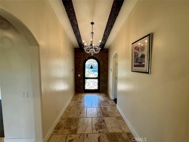 1415 Via Vallarta, Riverside, CA 92506 - doorway to outside featuring stone tile flooring, a chandelier, and arched walkways
