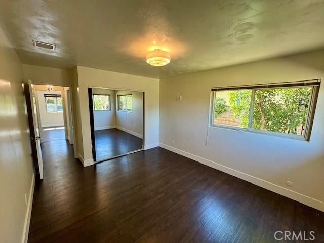 1415 Via Vallarta, Riverside, CA 92506 - unfurnished bedroom with dark wood-style flooring, a closet, and a baseboard heating unit
