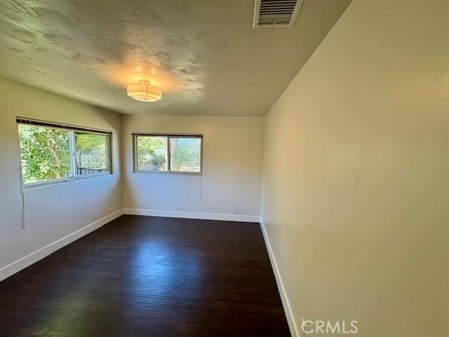 1415 Via Vallarta, Riverside, CA 92506 - empty room featuring baseboards and dark wood finished floors