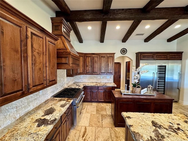 1415 Via Vallarta, Riverside, CA 92506 - kitchen featuring high quality appliances, tasteful backsplash, recessed lighting, stone tile floors, and beam ceiling