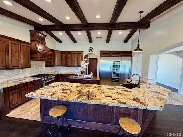 1415 Via Vallarta, Riverside, CA 92506 - kitchen with high quality appliances, tasteful backsplash, custom range hood, a large island with sink, and light stone counters