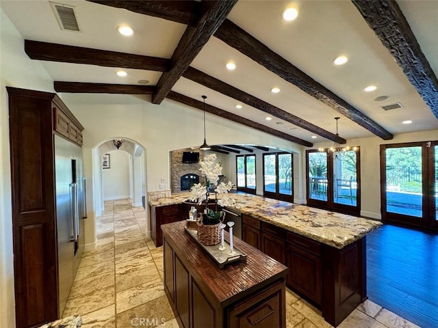 1415 Via Vallarta, Riverside, CA 92506 - kitchen with a center island, recessed lighting, arched walkways, appliances with stainless steel finishes, and dark brown cabinetry