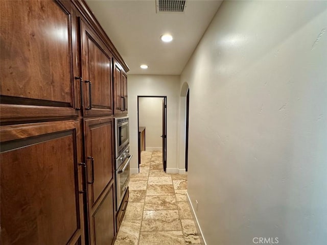 1415 Via Vallarta, Riverside, CA 92506 - corridor with arched walkways, stone tile flooring, and recessed lighting