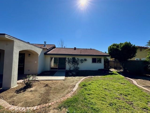1415 Via Vallarta, Riverside, CA 92506 - rear view of house featuring stucco siding, a tiled roof, and a patio area