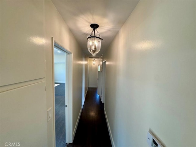 1415 Via Vallarta, Riverside, CA 92506 - hallway with dark wood-type flooring and a chandelier