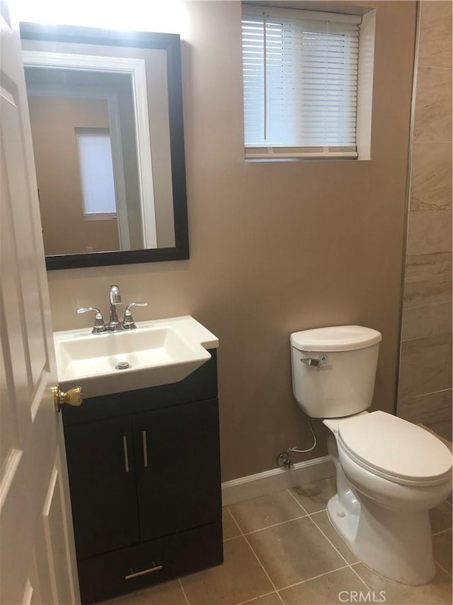 10022 Gothic Ave, North Hills, CA 91343 - bathroom with vanity, tile patterned flooring, toilet, and baseboards