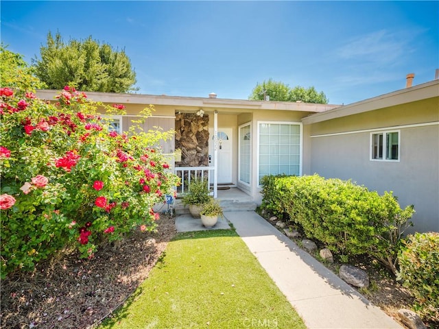 10022 Gothic Ave, North Hills, CA 91343 - view of exterior entry with a porch and stucco siding
