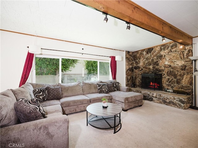 10022 Gothic Ave, North Hills, CA 91343 - carpeted living area with track lighting, a stone fireplace, and beamed ceiling