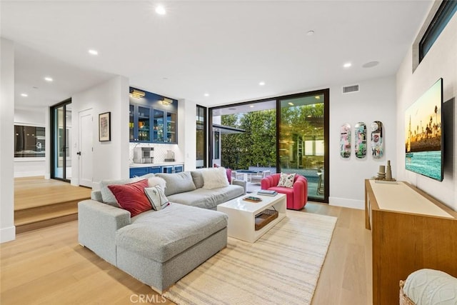 1010 Kings Rd, Newport Beach, CA 92663 - living room featuring light wood-style flooring, floor to ceiling windows, recessed lighting, and baseboards