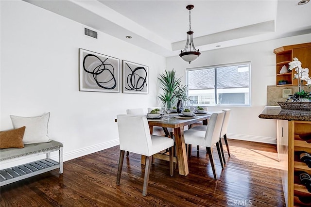 602 N Juanita Ave Unit A, Redondo Beach, CA 90277 - dining space with dark wood-type flooring, baseboards, and a tray ceiling